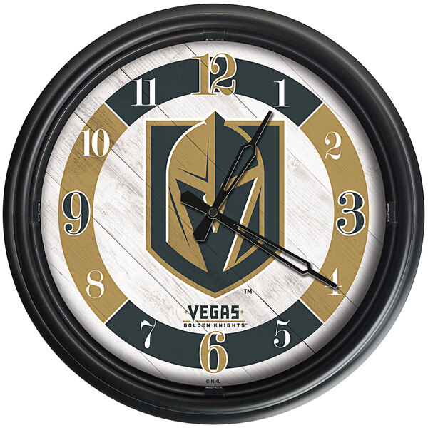 A Holland Bar Stool Vegas Golden Knights wall clock with gold and black clock hands and the team logo on it.
