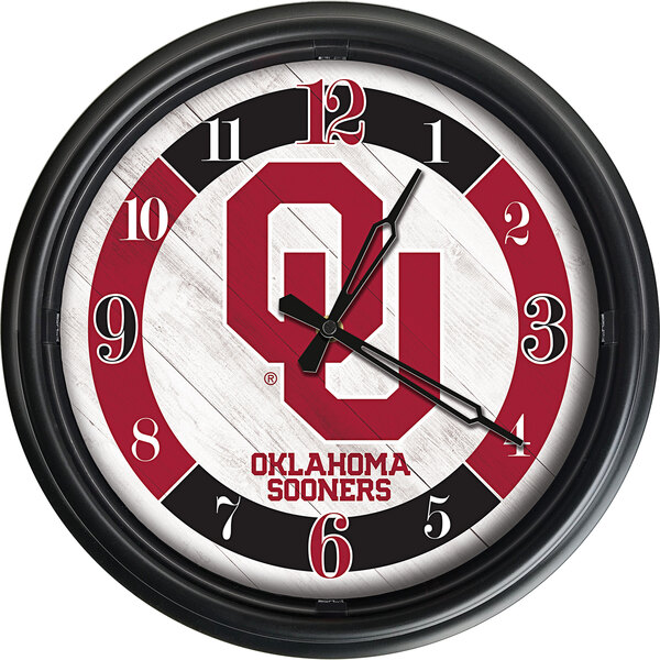 A white clock with a red and black Oklahoma University logo.