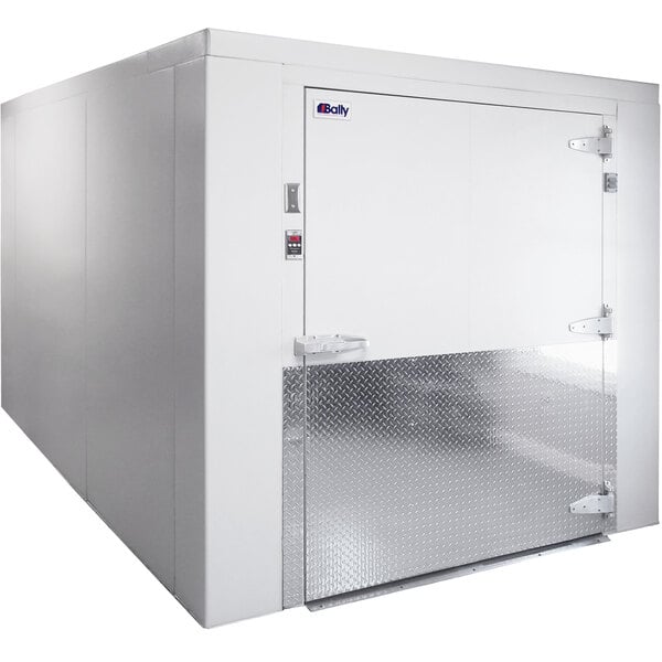 A Bally walk-in freezer with an open door in a white room.