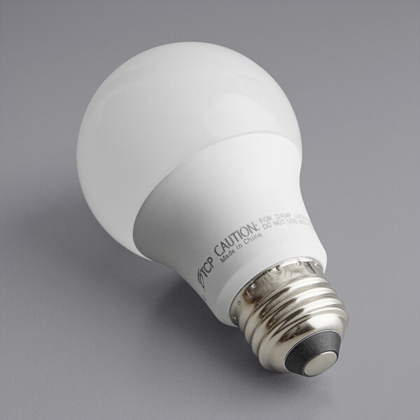 A TCP A19 LED light bulb with a label.