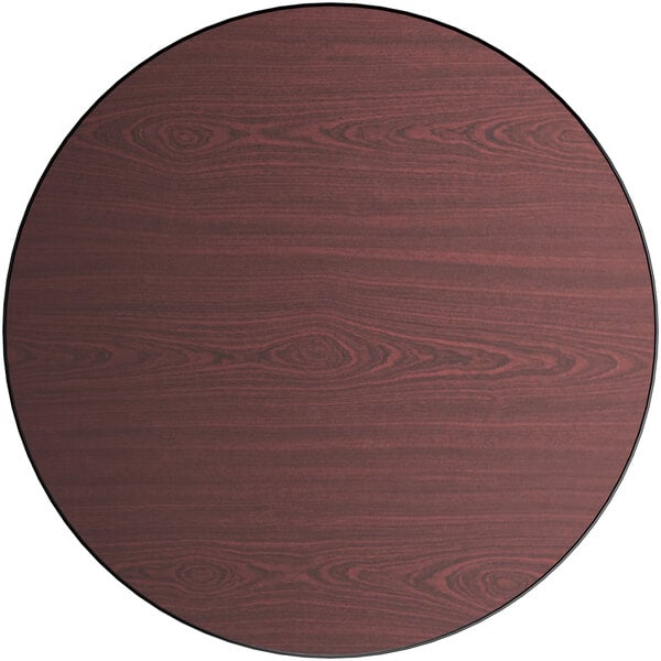 A Lancaster Table & Seating laminated round table top with a cherry wood center and black border.