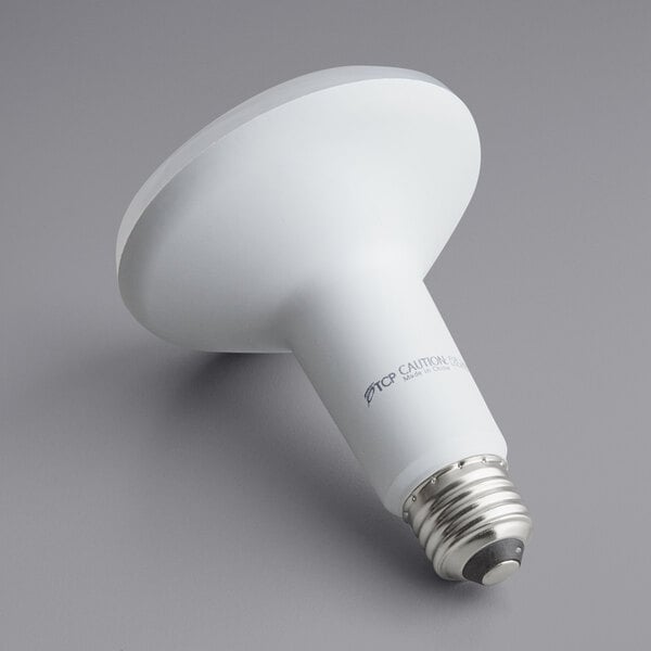 A TCP dimmable LED light bulb with white casing and light on.