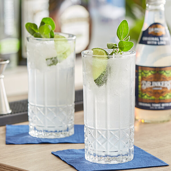Two glasses of Dr.inkers' Choice Lime Tonic Water with ice, lime, and mint.