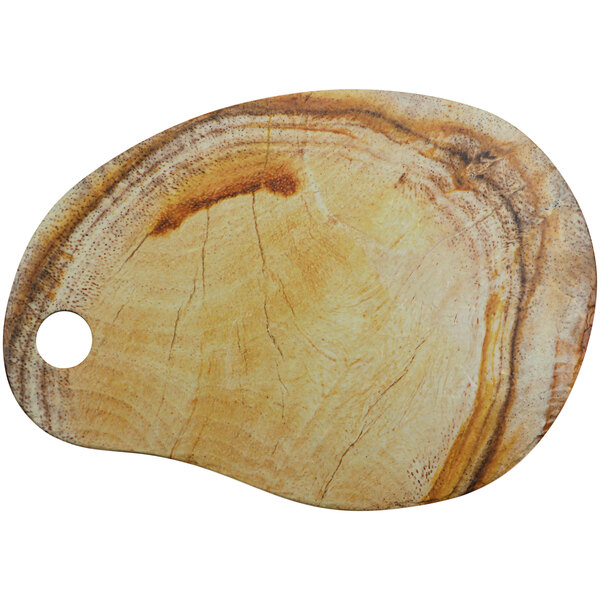 A cheforward oval melamine serving platter with a tropical design on a wooden cutting board.