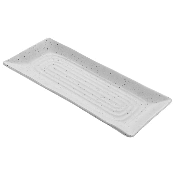 A white rectangular melamine platter with black specks.