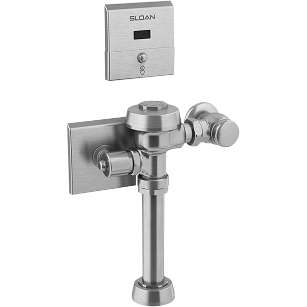 A silver metal Sloan Royal water closet flushometer with a button.
