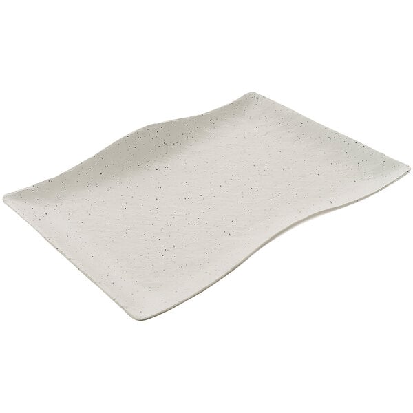 A white rectangular cheforward melamine platter with a wavy design.