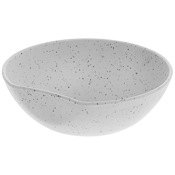 A white bowl with black specks.