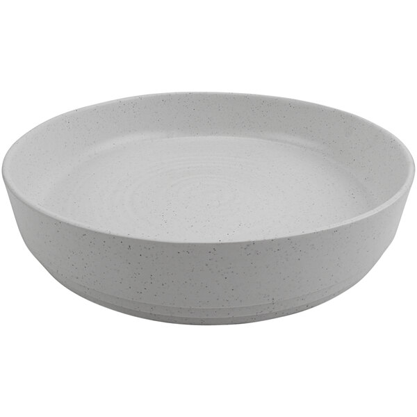 A white round melamine platter with a speckled surface and raised rim.