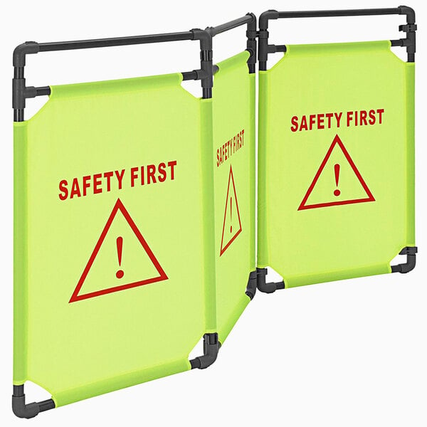 A yellow Vestil "Safety First" portable safety barrier with red text.