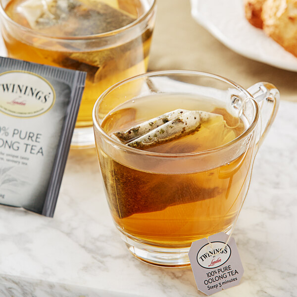 A glass of Twinings Oolong Tea with a tea bag in it.