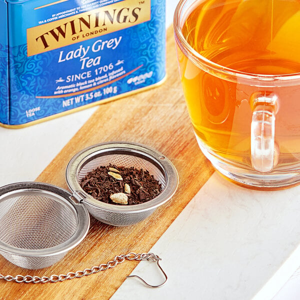 A glass cup of Twinings Lady Grey Tea.