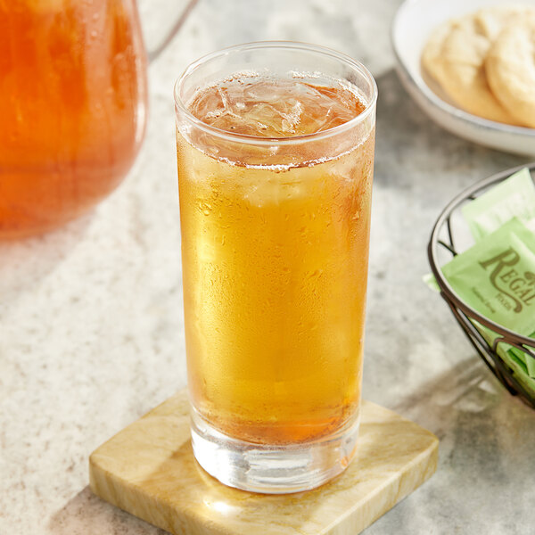 A glass of Twinings iced tea on a marble surface.