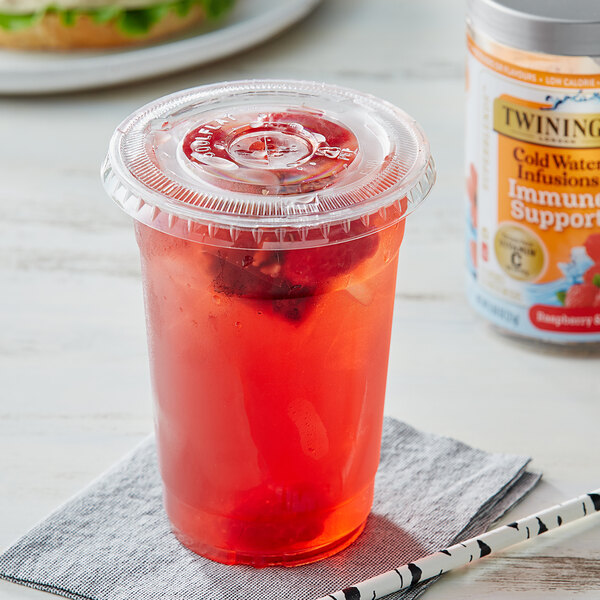 A plastic cup with red Twinings Cold Infuse Immune Support Raspberry & Hibiscus liquid and a white and black straw.