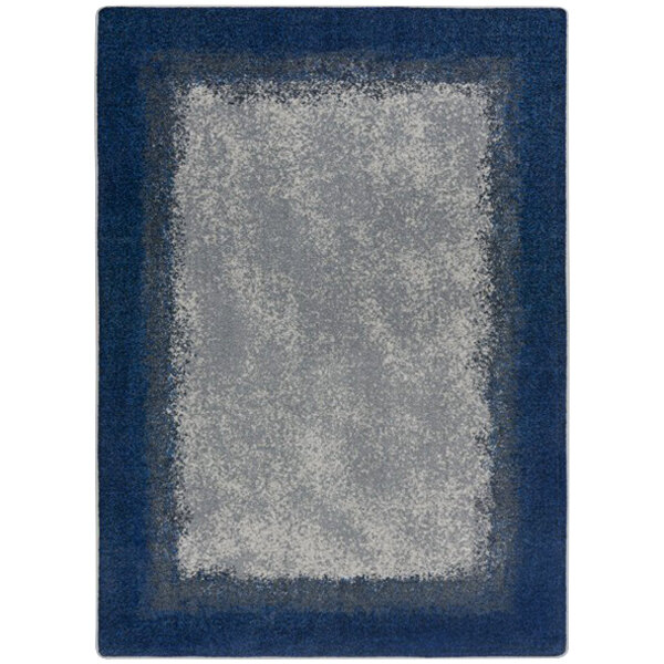 A rectangular marine blue rug with a gray border and blue and white geometric shapes.