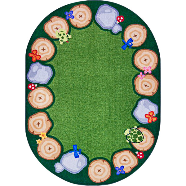 A multicolored oval rug with a green border and a tree and flower design on a white background.