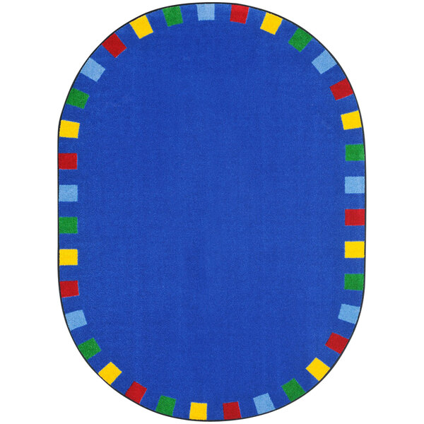 A blue oval rug with a colorful border and multicolored squares.