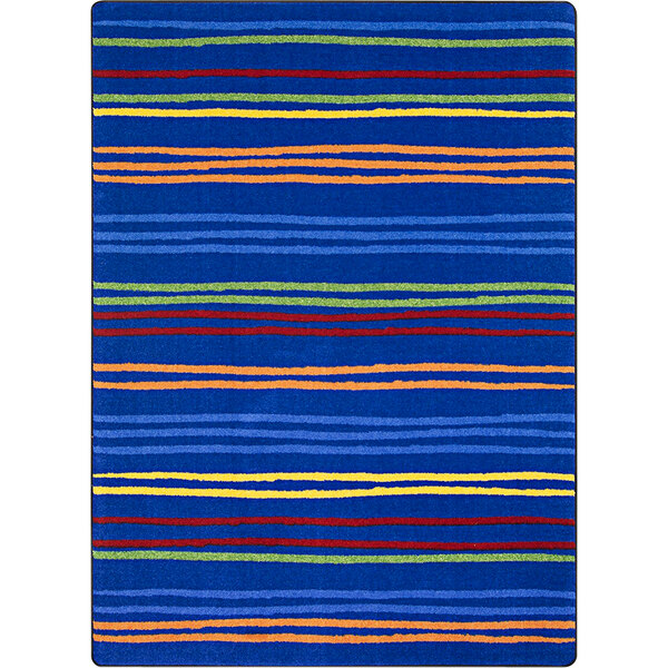 A blue Joy Carpets Kid Essentials area rug with multicolored stripes in blue, orange, and green.