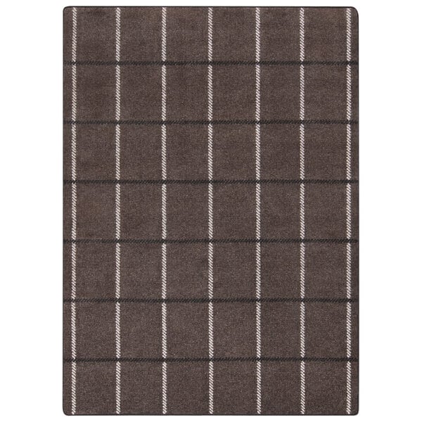 A close-up of a brown and white plaid Joy Carpets area rug.