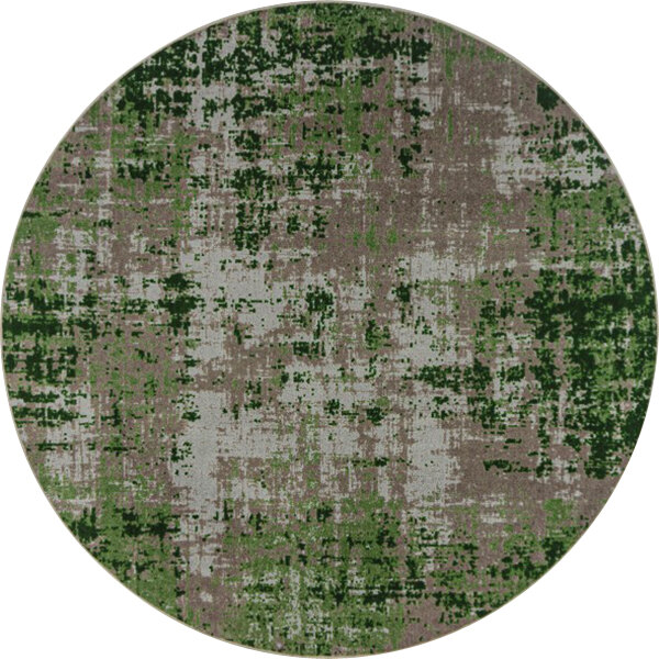 A close-up of a round Joy Carpets area rug with green and grey stains on a white and green surface.