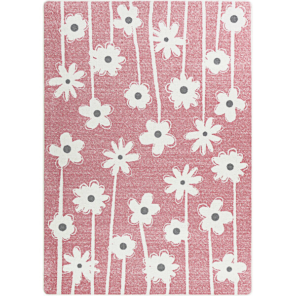 A blush pink area rug with white flowers on it.