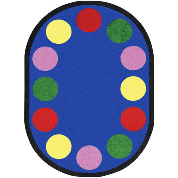 A multicolored oval rug with colorful circles in a room.