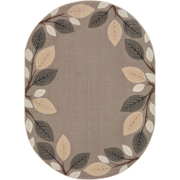 An oval neutral rug with branches and leaves on it.