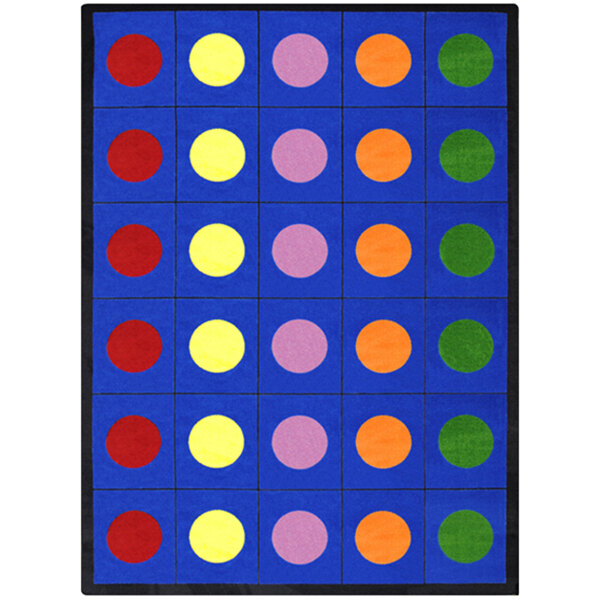 A blue rectangular area rug with multicolored circles on it.