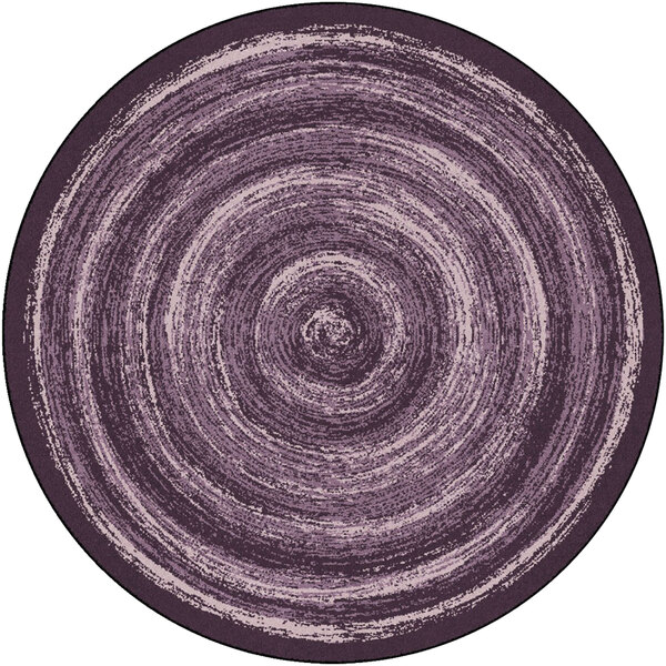 A purple circular rug with a spiral pattern.