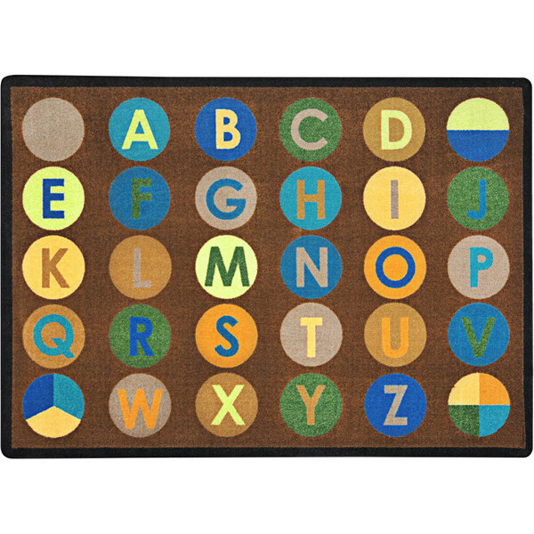 A close up of a Joy Carpets Earthtone area rug with letters and numbers in colorful dots.