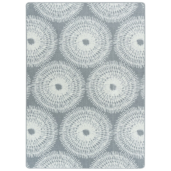 A Joy Carpets rectangular area rug with a grey and white circular pattern.