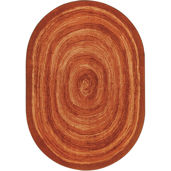 An orange oval Joy Carpets area rug with a circular design.