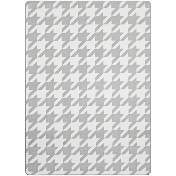 A grey and white patterned rug with a white border.
