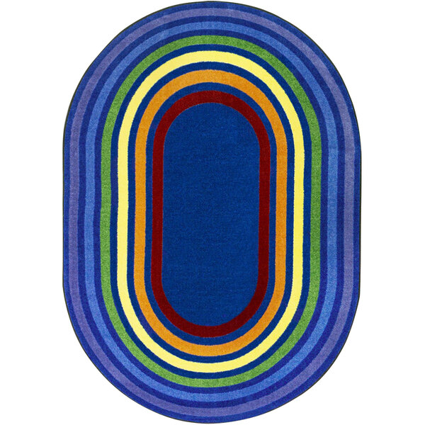 A multicolored oval area rug with rainbow rings in a room.