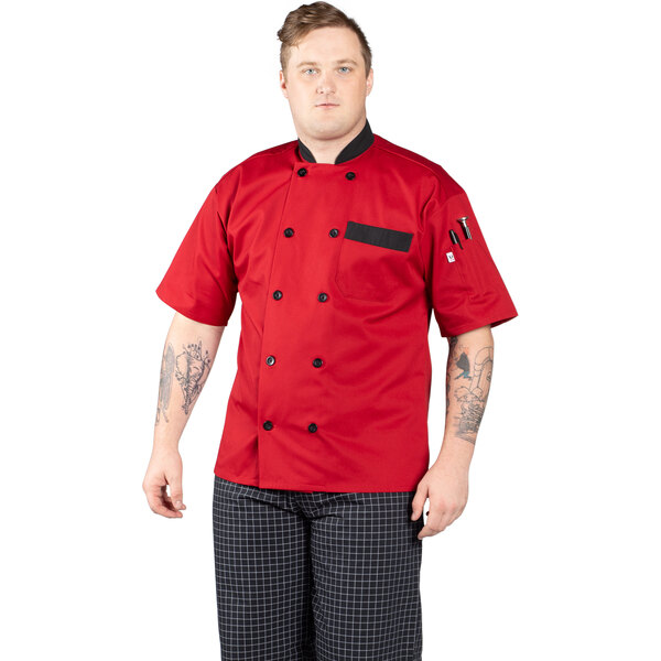 A man wearing a red Uncommon Chef Bristol chef coat with black trim.