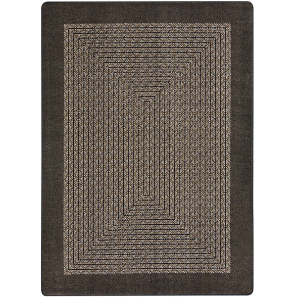 A close-up of a chocolate brown rectangular area rug with a geometric design.