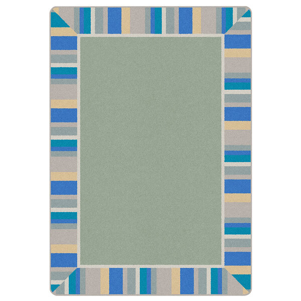 A Joy Carpets rectangular area rug with a white background and blue, green, and yellow border.
