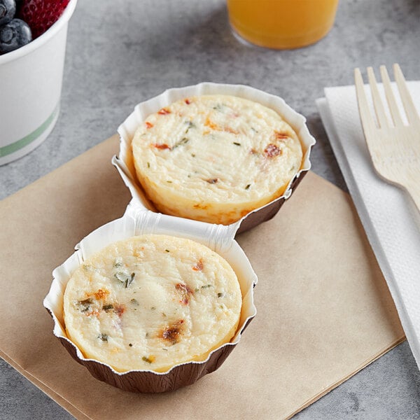 Artisan Kitchens Veggie and Three Cheese Egg White Bites in paper cups.