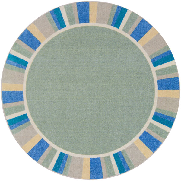 A round sage green rug with a blue and yellow border.
