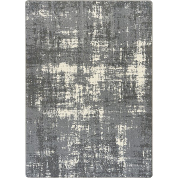 A close-up of a grey and white Joy Carpets Westmarch area rug with a distressed pattern.