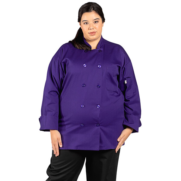 A woman wearing an eggplant purple Uncommon Chef short sleeve chef coat.