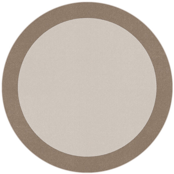 A white and beige round area rug with a border on a white and brown table.
