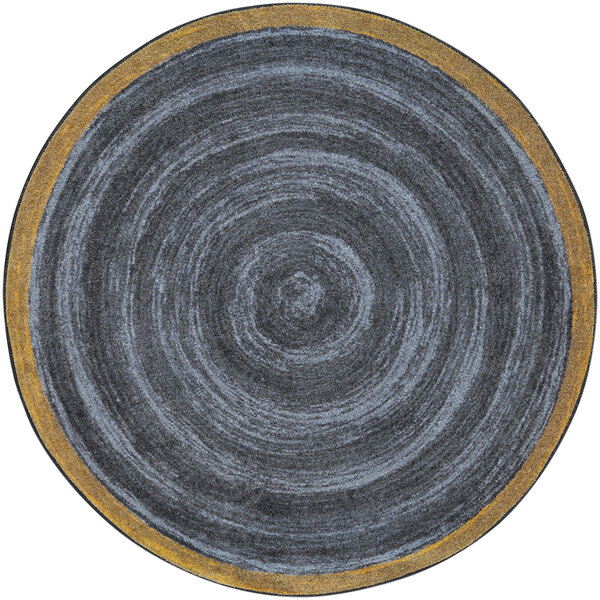 A close up of a grey circle with a yellow border on a slate grey background.