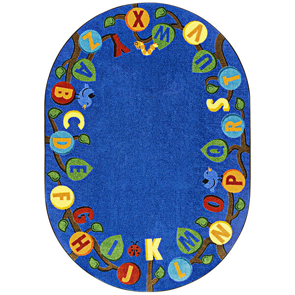 A multi-colored oval rug with a blue background and letters on it in a room.