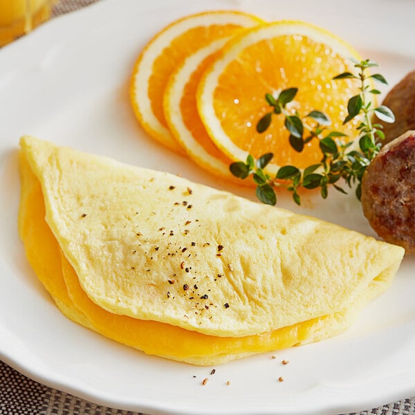 A Papetti's cheese omelet on a plate with orange slices.