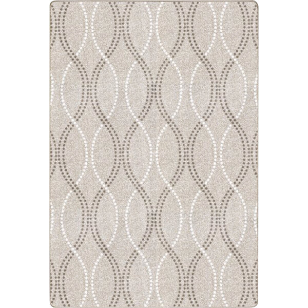A beige Joy Carpets rectangular area rug with a pattern of circles.