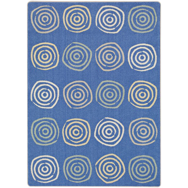A blue rug with white circles on it.