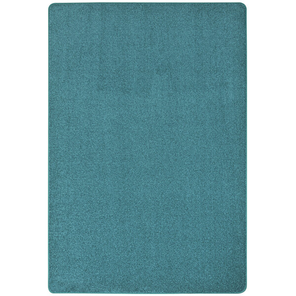 A mint green Joy Carpets Kid Essentials area rug with a teal and blue pattern.