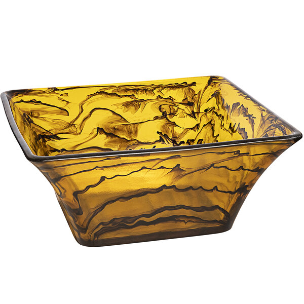 A square yellow bowl with black swirls.