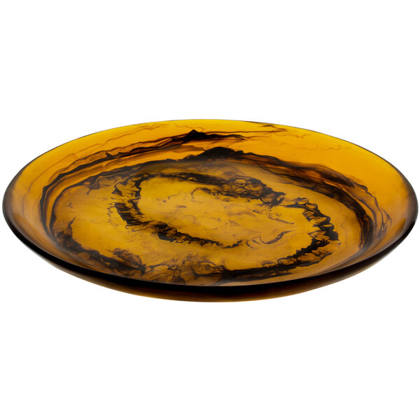 A Bon Chef round umber resin platter with yellow and black swirls.